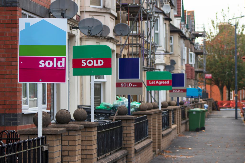 Property Sales. Estate Agents Sold Signs on UK Terraced Houses