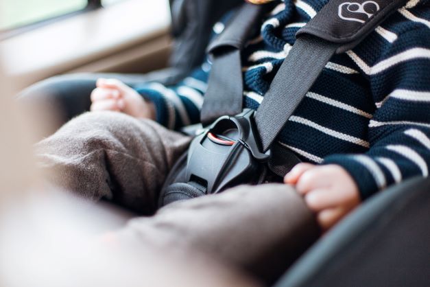 child strapped in a car seat.