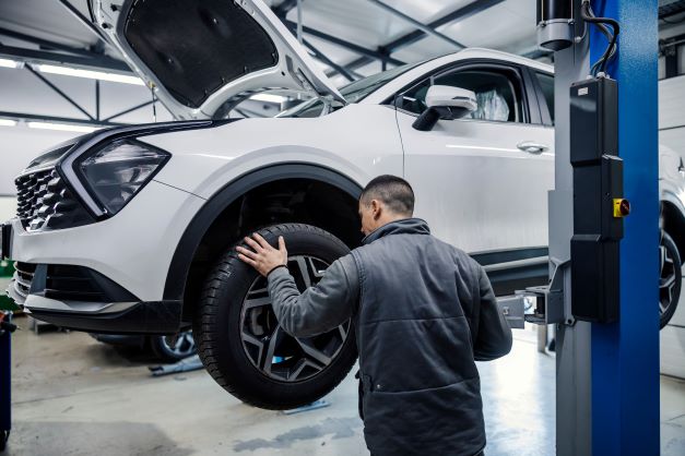 a car at the garage having the wheels changed