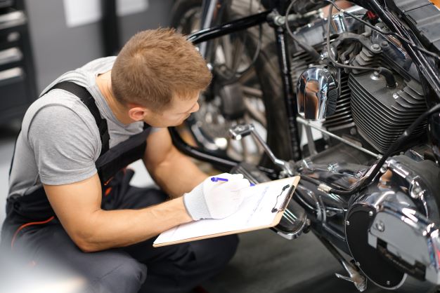 A motorcycle MOT inspection conducted by a mechanic.