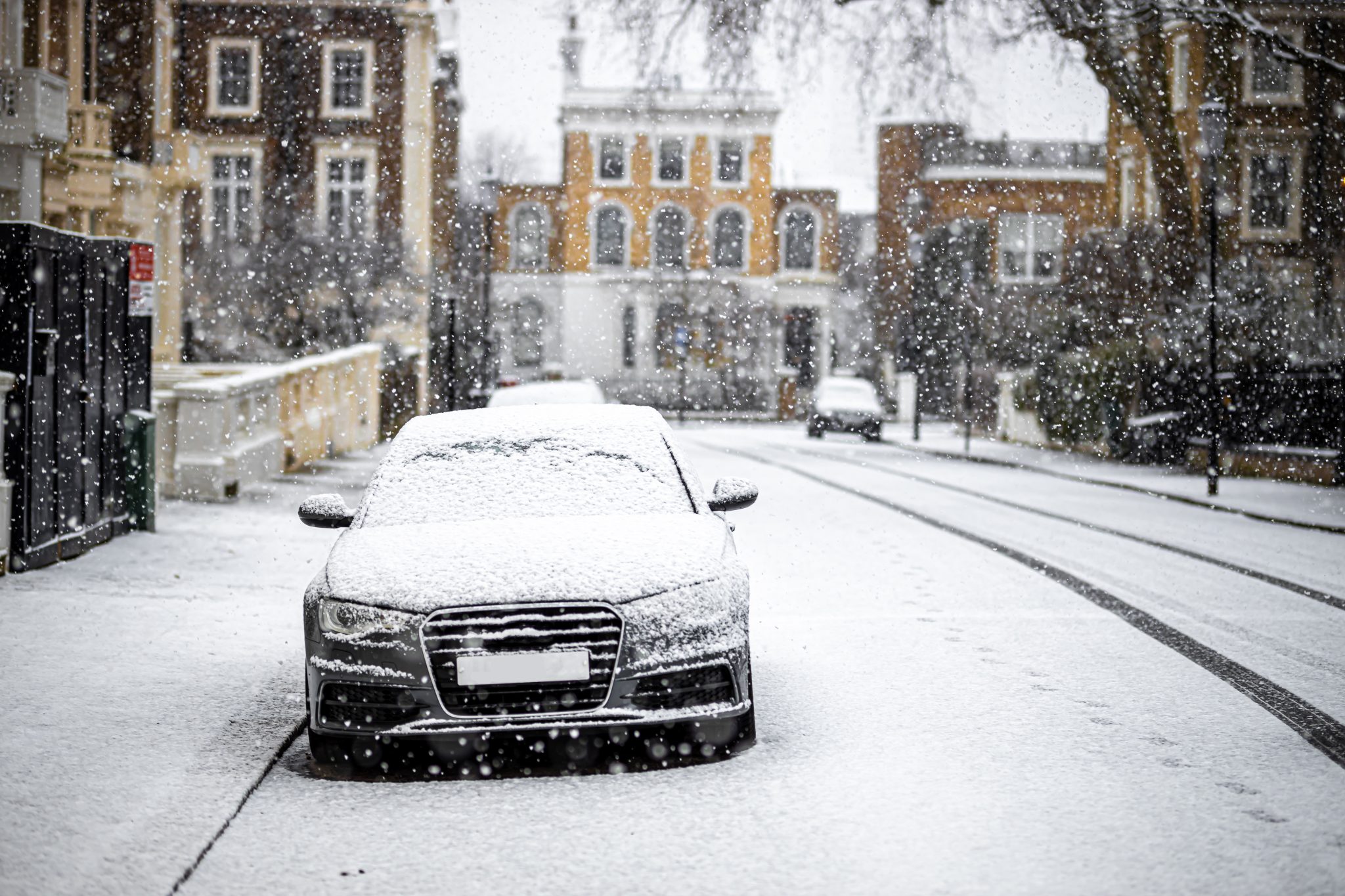 black car parked on a snowy street in London